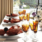 Mario Luca Giusti Dolce Vita Champagne Flute, Amber in synthetic crystal, styled in a table setting