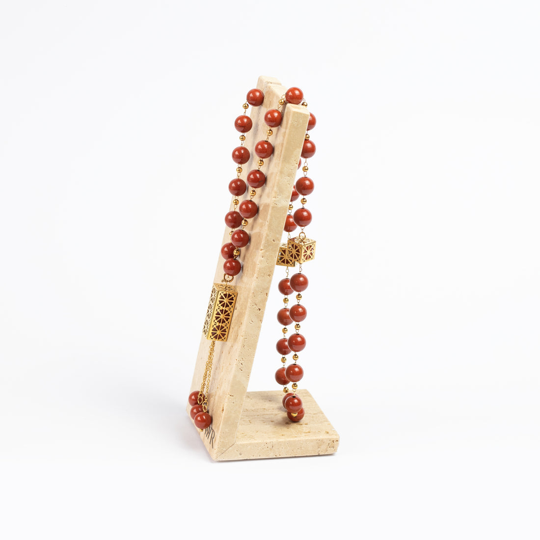 Zoya Stones Red Jasper masbaha with travertine stand, front view